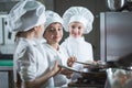 Children cook eggs in the kitchen at the Restaurant.