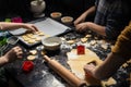 Children cook New Year`s cookies together. Carving Christmas trees and stars out of dough. Preparation for the holiday. Homemade