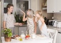 Children cooking making pizza at home. Teen boy and his sisters having fun in the kitchen. People teenagers and leisure concept