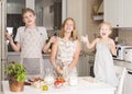 Children cooking making pizza at home. Teen boy and his sisters having fun in the kitchen. People teenagers and leisure concept