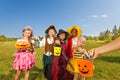 Children in costumes look at hand with sweets Royalty Free Stock Photo