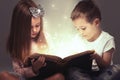 Children couple opened a magic book