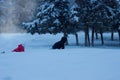 Children crawl through the snow one after another