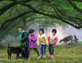 Children crossing farm field, China countryside Royalty Free Stock Photo