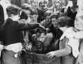 Children crowded around apple bobbing Royalty Free Stock Photo