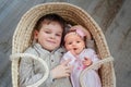 Children, cute little boy 5 years old, with him newborn sister lies in a wicker cradle Royalty Free Stock Photo