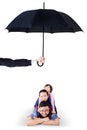 Children and dad lying in studio under umbrella Royalty Free Stock Photo