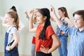 Group Of Children Dancing In Drama Class Together