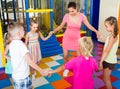 Children dancing with teacher to music in class at school Royalty Free Stock Photo