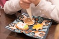 Children decorate cookies for New Year and Christmas