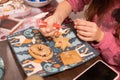 Children decorate cookies for New Year and Christmas