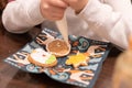 Children decorate cookies for New Year and Christmas