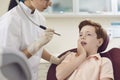 Children dental clinic. Little boy sits in a dentist chair and suffers from severe toothache. Royalty Free Stock Photo