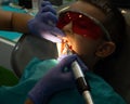 Children dental dentist treats a little boy tooth in the office clinic Royalty Free Stock Photo