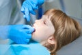 Children dentistry. Liitle girl an dentist examination, teeth cleaning and treatment.