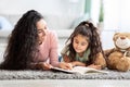 Children Development Concept. Loving Young Mom Reading Book To Her Little Daughter