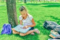 Children do homework in the park, a boy and a girl are preparing Royalty Free Stock Photo