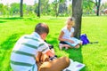 Children do homework in the park, a boy and a girl are preparing for school Royalty Free Stock Photo