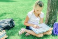 Children do homework in the park, a boy and a girl are preparing Royalty Free Stock Photo