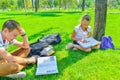 Children do homework in the park, a boy and a girl are preparing for school Royalty Free Stock Photo