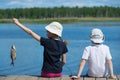Children on the dock with fish Royalty Free Stock Photo