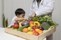 Children and doctors happy to have healthy food.Kid learning about nutrition with doctor to choose eating fresh fruits and Royalty Free Stock Photo