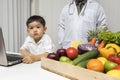 Children and doctors happy to have healthy food..Kid learning about nutrition with doctor to choose eating fresh fruits and Royalty Free Stock Photo