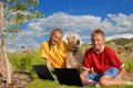 Children with dog and laptops Royalty Free Stock Photo