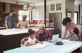 Children Doing Homework In Busy Multi Generation Family Home Royalty Free Stock Photo