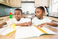 Children doing homework in the kitchen Royalty Free Stock Photo