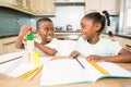 Children doing homework in the kitchen Royalty Free Stock Photo