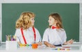 Children doing school lesson at class. Funny school girl an boy pupil drawing a picture. Cute little preschoolers Royalty Free Stock Photo