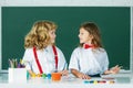 Children doing school lesson at class. Funny school girl an boy pupil drawing a picture. Cute little preschoolers Royalty Free Stock Photo