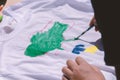 Children draw a map of Ukraine on a T-shirt