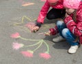 Children drawing on the asphalt.
