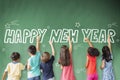 Children drawing happy new year on the chalkboard