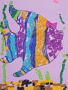 Children drawing multicolored fish