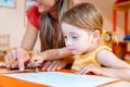 Children drawing with pencils in play school