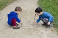 Children drawing into sand