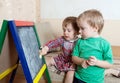 Children draws on blackboard with chalk