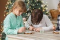 Children draws food paints on Christmas homemade gingerbread cookies. Christmas concept