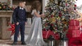 Children dressed in elegant clothes adorn a tree of roses. festive mood