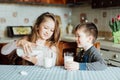 Children drink milk in the kitchen at the morning. Royalty Free Stock Photo