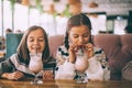 Children drink smoothie in family cafe