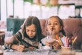 Children drink smoothie in family cafe