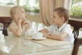 Children drink tea in cafe