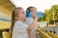 Children drink water in the stadium