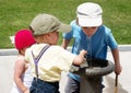 Children drinking water in a drinking fountain Royalty Free Stock Photo