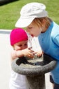 Children drinking water in a drinking fountain Royalty Free Stock Photo