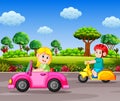 The children drive the transportation on the street with the garden background